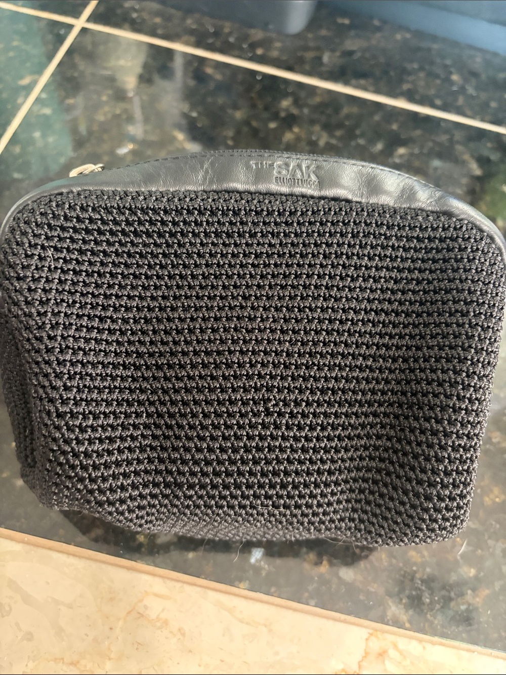 The Sak Black Crochet Toiletry Pouch with Leather Trim